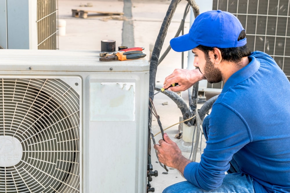 Technician installing AC unit